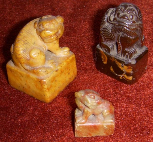 Three Old Chinese Foo Dog Chops in Amber and Stone, Possibly 18th Century or Earlier